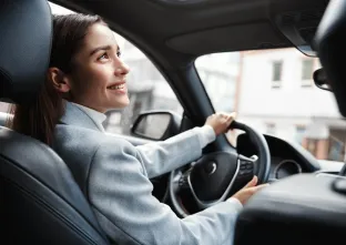 woman smiles up in a car 
